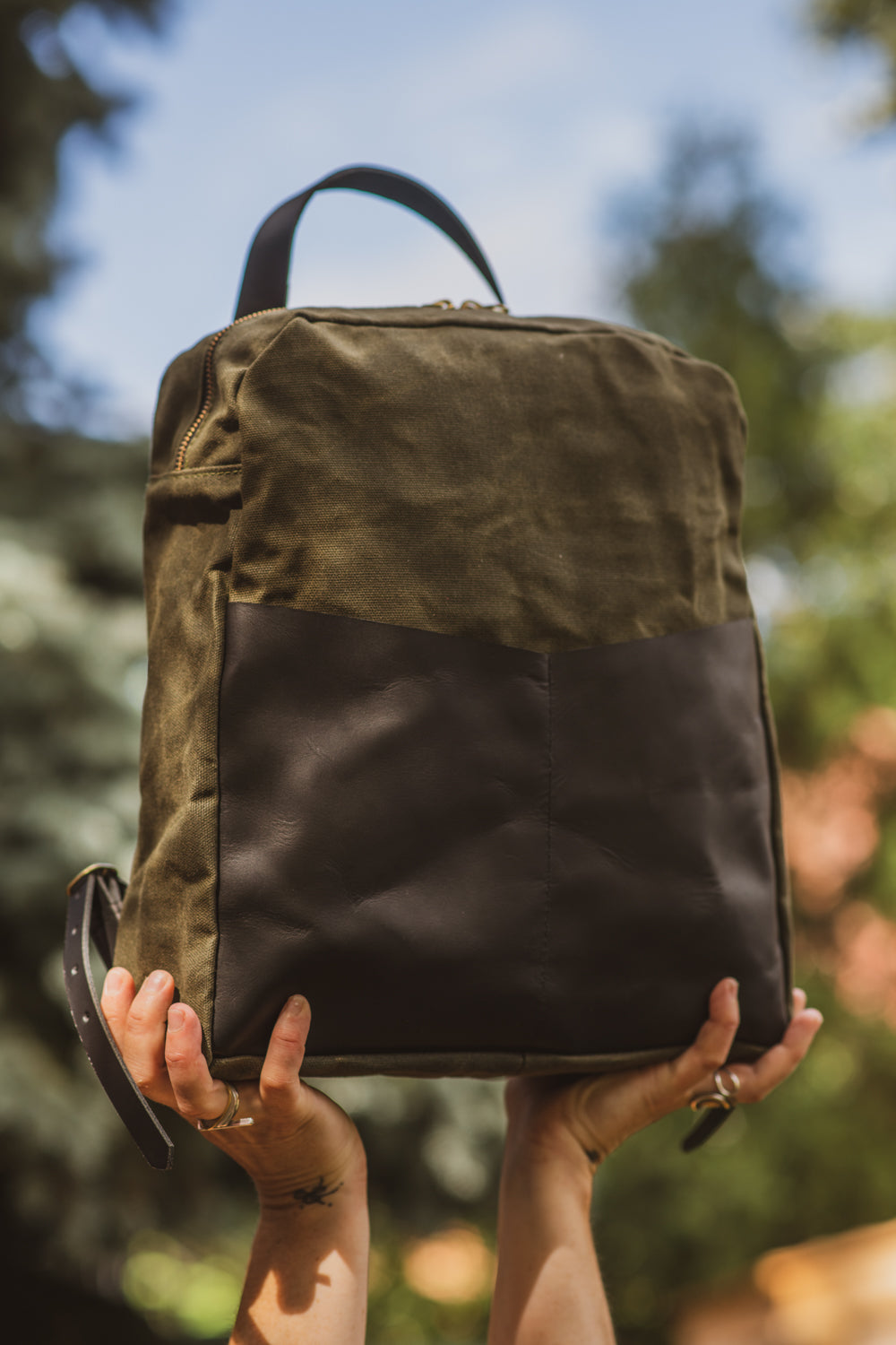 Veinage Gilford black leather and army green waxed canvas backpack, handmade in Montreal Canada