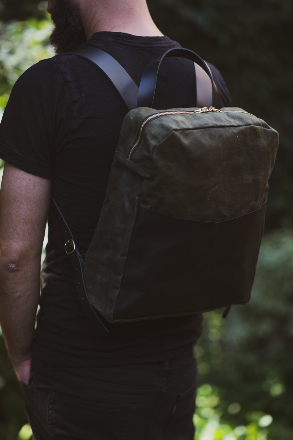 Veinage Gilford black leather and army green waxed canvas backpack, handmade in Montreal Canada