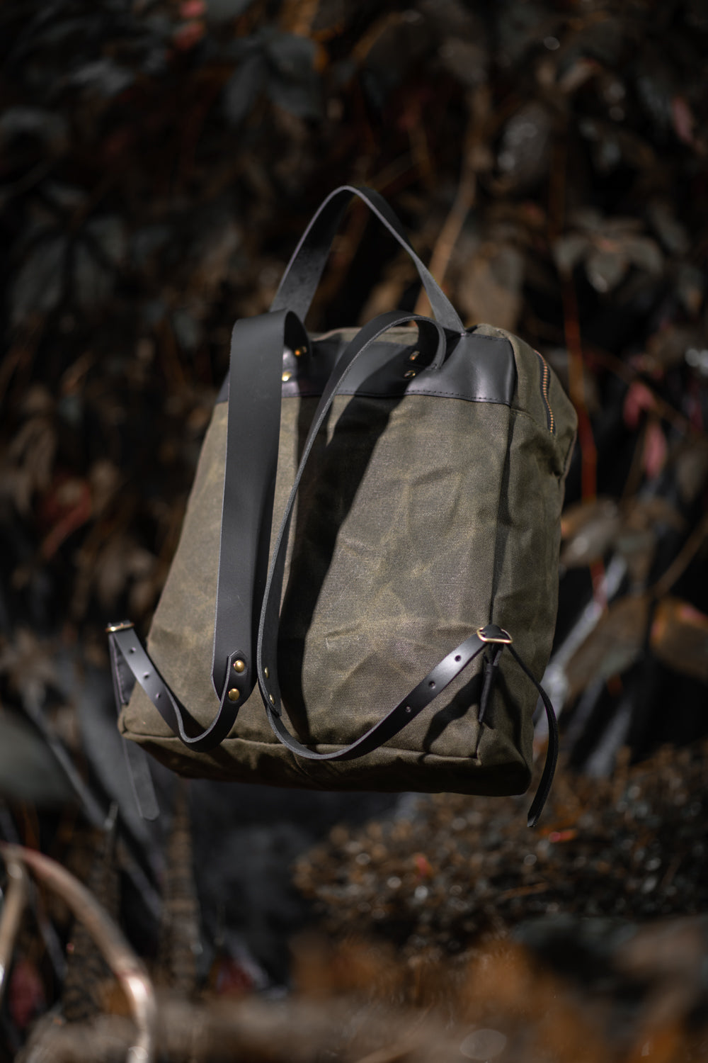 Veinage Gilford black leather and army green waxed canvas backpack, handmade in Montreal Canada