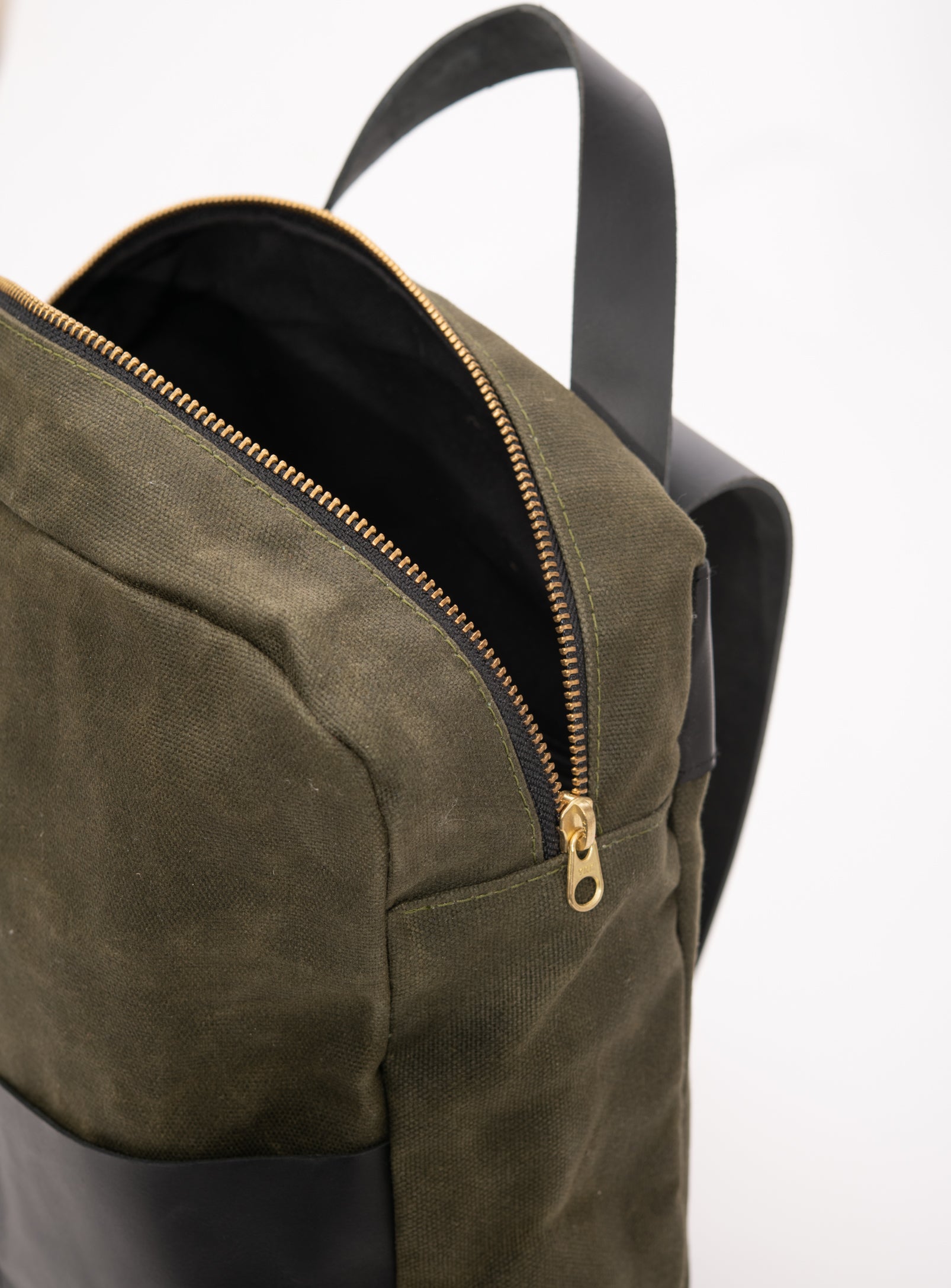 Veinage Gilford black leather and army green waxed canvas backpack, handmade in Montreal Canada